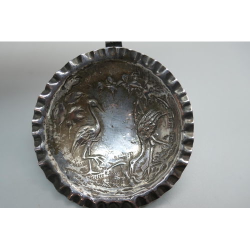 873 - A ladle embossed with storks, London 1902 import mark, 26g, bowl 57mm diameter