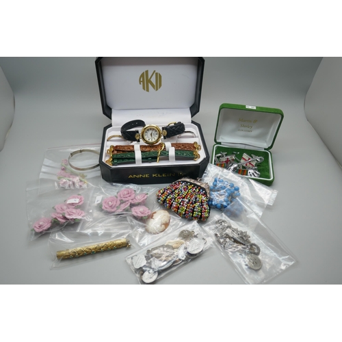 877 - Costume jewellery, etc., including a small silver bangle, a gold tone and stone set pen, charms, an ... 