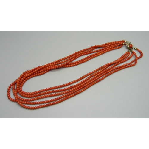 949 - A five strand coral necklace with coral set clasp, clasp a/f, 46g, 42cm