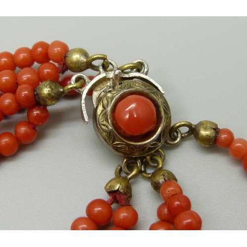 949 - A five strand coral necklace with coral set clasp, clasp a/f, 46g, 42cm