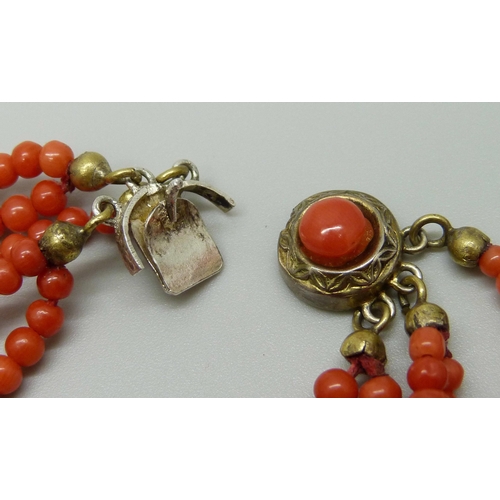 949 - A five strand coral necklace with coral set clasp, clasp a/f, 46g, 42cm