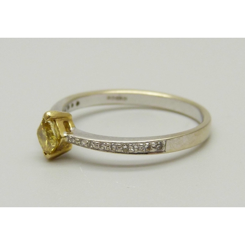 967 - An 18ct gold ring set with a yellow diamond and diamond shoulders, 1.8g, N