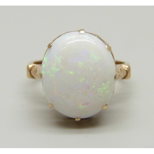 968 - A yellow metal ring set with an opal in a claw setting, tests as gold, marked 14 on the outside of t... 