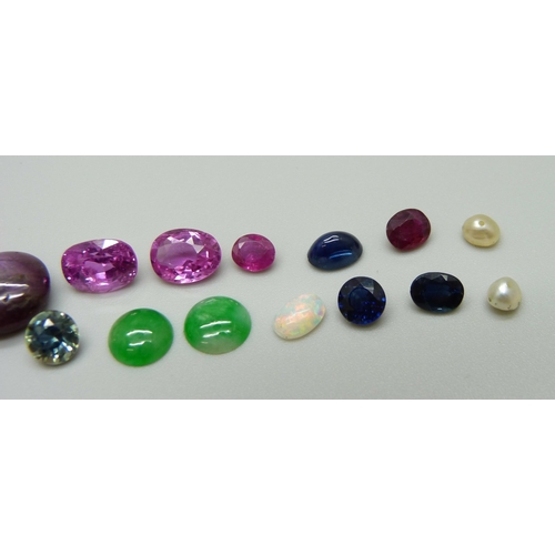 969 - A collection of unmounted stones including black opal, a pair of pink tourmaline, jade, ruby, sapphi... 