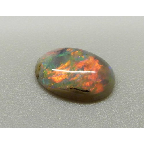 969 - A collection of unmounted stones including black opal, a pair of pink tourmaline, jade, ruby, sapphi... 