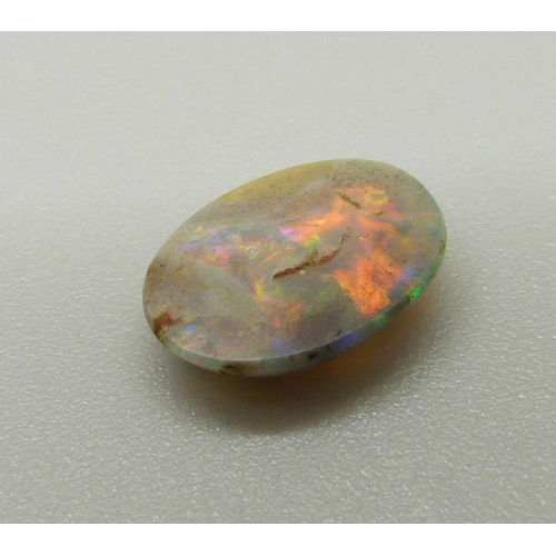 969 - A collection of unmounted stones including black opal, a pair of pink tourmaline, jade, ruby, sapphi... 