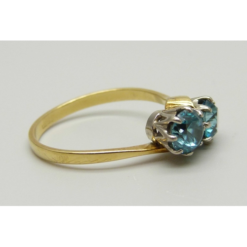 970 - An 18ct gold ring set with two blue zircon stones in a crossover design, 3.5g, Q