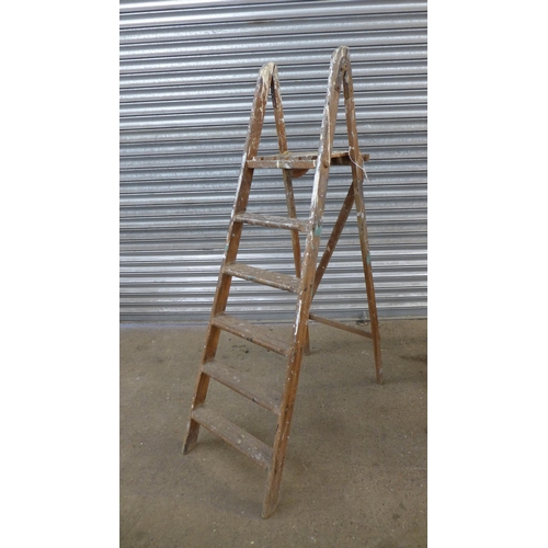 3 Wooden ladders; a 6-rung step ladder, a 7-rung step ladder and a 12 ...