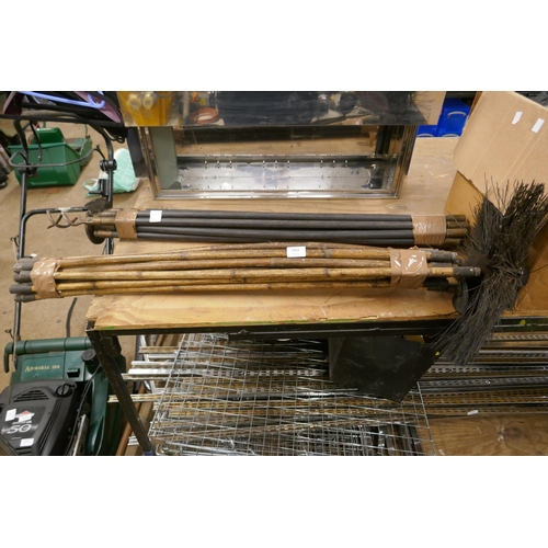 2464 - A bundle of drain rods and a bundle of chimney sweeping rods