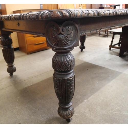 107 - A Victorian carved oak dining table