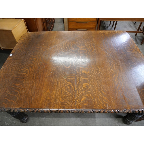 107 - A Victorian carved oak dining table