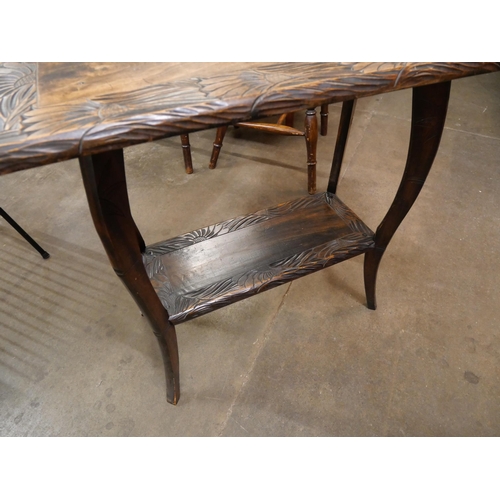 110 - An Arts and Crafts Liberty & Co. carved wood Japanese range occasional table