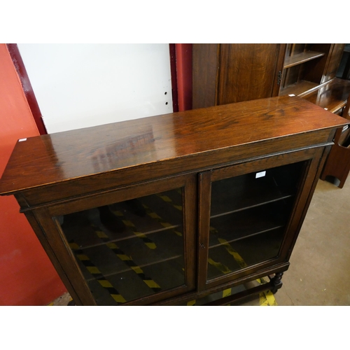 112 - An early 20th Century oak barleytwist two door bookcase