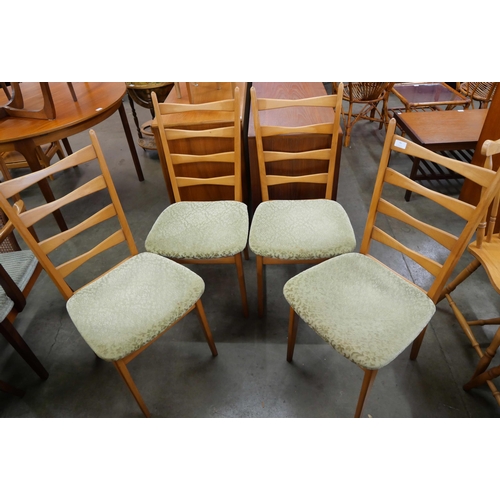 79 - A set of four teak dining chairs