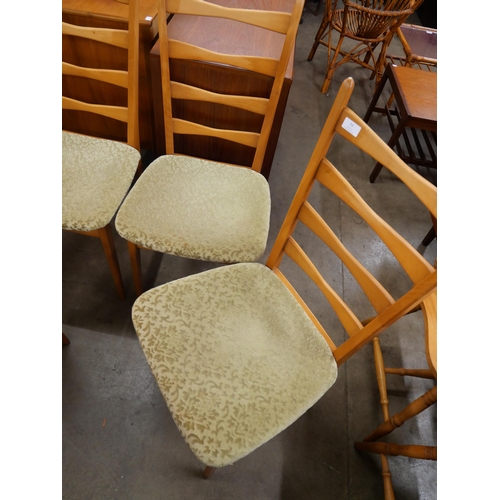 79 - A set of four teak dining chairs