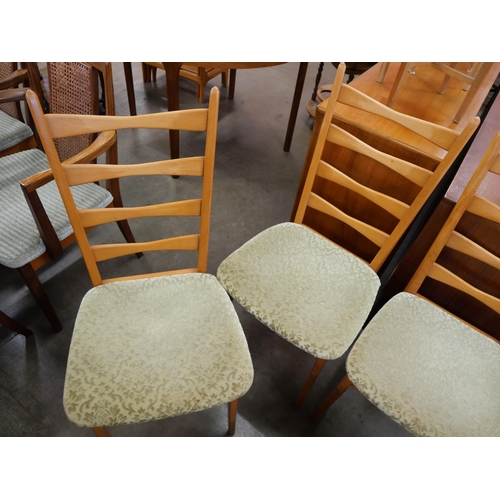 79 - A set of four teak dining chairs