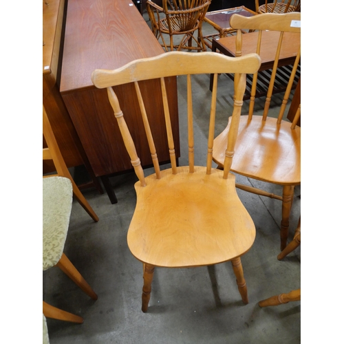 80 - A set of four beech spindle back kitchen chairs