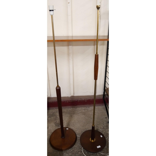 85 - Two teak standard lamps