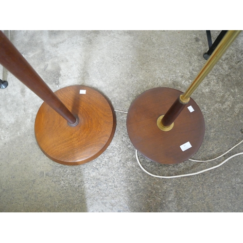 85 - Two teak standard lamps