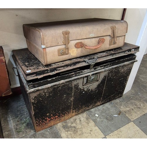 380 - A black metal trunk and a suitcase