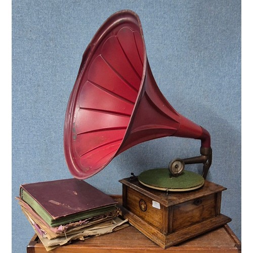 385 - A Beltons wind-up table top gramophone with large red metal speaker horn, with records, handle and n... 