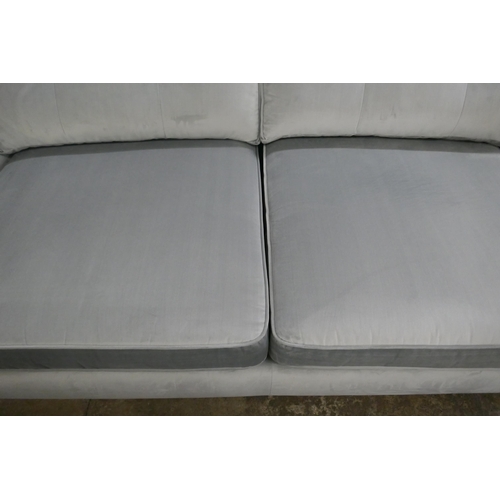 1432 - A pewter velvet three seater sofa