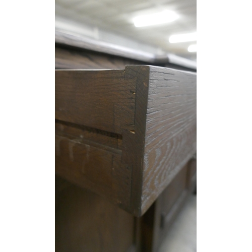 1449 - A four door dark oak sideboard