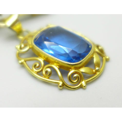 1003 - An 18ct gold pendant set with a blue stone, on a yellow metal brooch mount in the form of a bow, 6.7... 