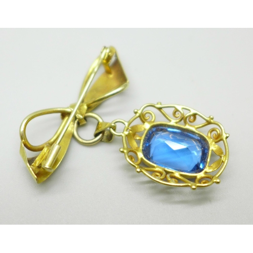 1003 - An 18ct gold pendant set with a blue stone, on a yellow metal brooch mount in the form of a bow, 6.7... 