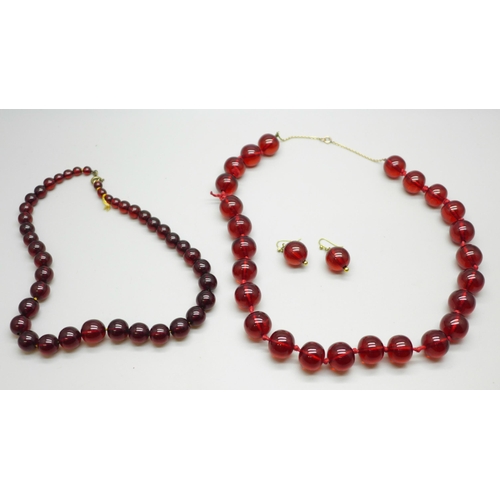 1013 - Two sherry amber coloured bead necklaces with a similar pair of earrings