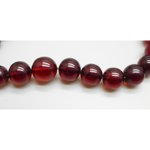 1013 - Two sherry amber coloured bead necklaces with a similar pair of earrings