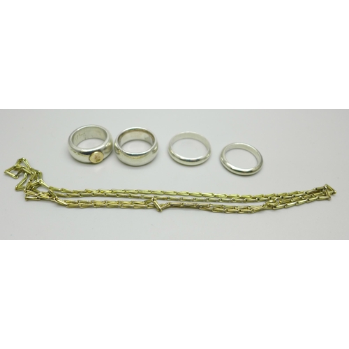 1037 - Three silver rings, one with a 14ct gold applied detail (marked 585), a white metal ring and a plate... 