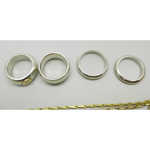 1037 - Three silver rings, one with a 14ct gold applied detail (marked 585), a white metal ring and a plate... 