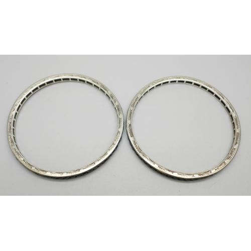 1038 - Two white metal bangles set with blue glass stones