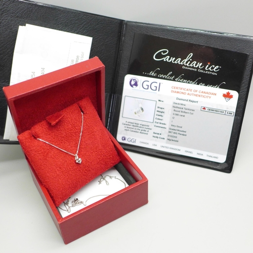 1050A - A 9ct white gold and diamond pendant on a fine 9ct white gold chain, 0.9g, chain 41cm, with Canadian... 