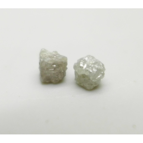 1060 - Two rough/uncut diamonds, total weight 1.35cts