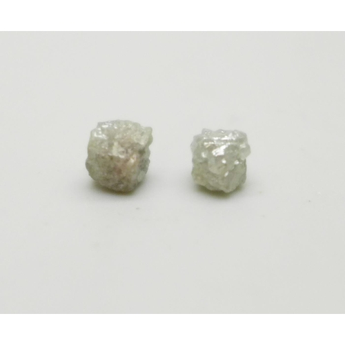 1060 - Two rough/uncut diamonds, total weight 1.35cts