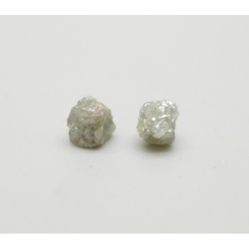 1060 - Two rough/uncut diamonds, total weight 1.35cts