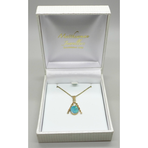 1064 - A yellow metal and opal pendant, 1.2g on a gilt metal chain