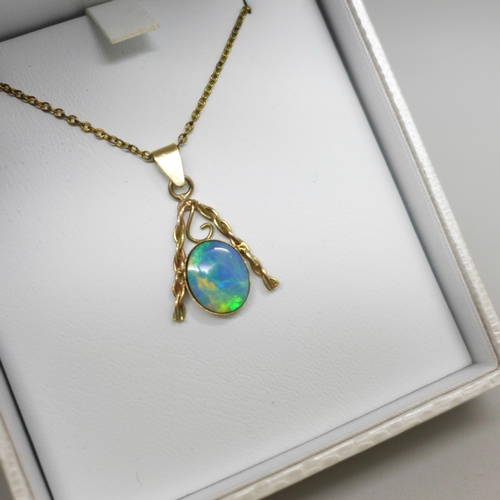 1064 - A yellow metal and opal pendant, 1.2g on a gilt metal chain