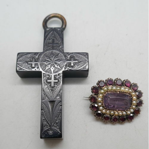 1113 - A jet cross pendant with detail and a Georgian gold toned garnet, seed pearl and amethyst brooch