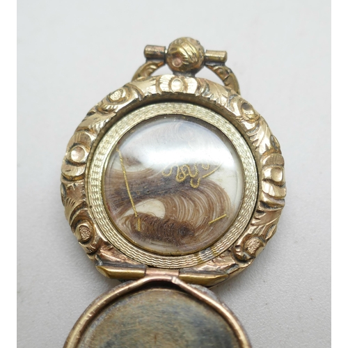 1118 - A small Georgian gold toned mourning brooch, an early Victorian gold toned memorial locket pendant w... 