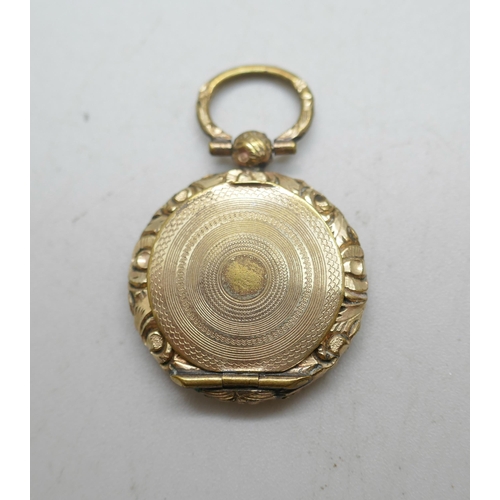 1118 - A small Georgian gold toned mourning brooch, an early Victorian gold toned memorial locket pendant w... 