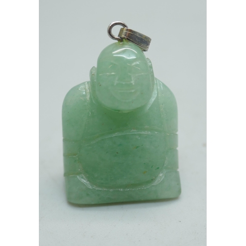 1121 - An ice green jade carved laughing Buddha pendant, a jade ring, a small carved jade ram pendant and a... 