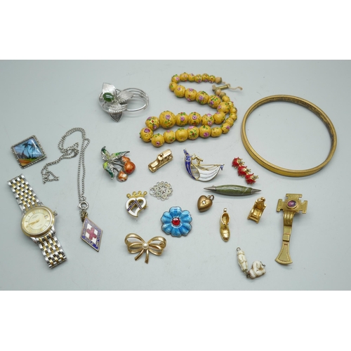 1123 - A gold colour bangle, a lady's Rotary watch and a collection of brooches, charms, etc.