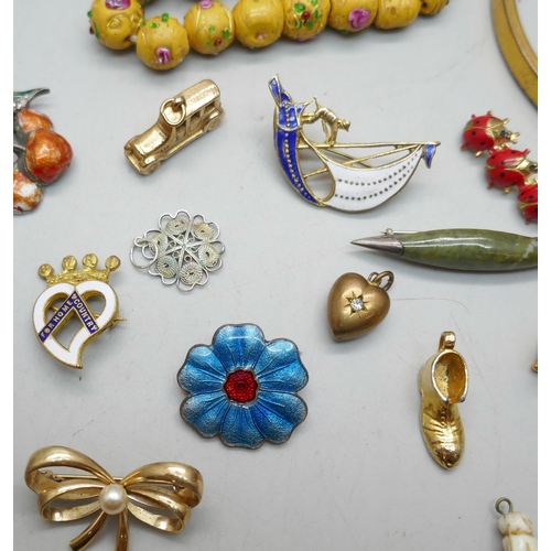 1123 - A gold colour bangle, a lady's Rotary watch and a collection of brooches, charms, etc.