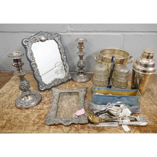 1127 - A pair of plate on copper candlesticks, a cocktail shaker, an ice bucket, a mirror, a photograph fra... 