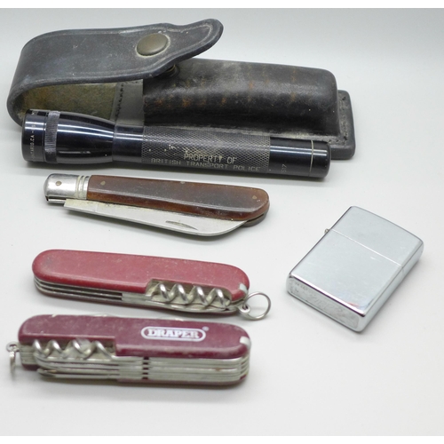 623 - A Zippo lighter, a Swiss Army knife, two other knives and a British Transport Police Mini-Maglite to... 