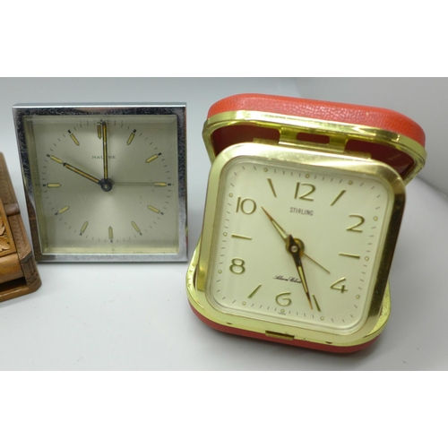 629 - Two carved wood watch holders and vintage travel clocks