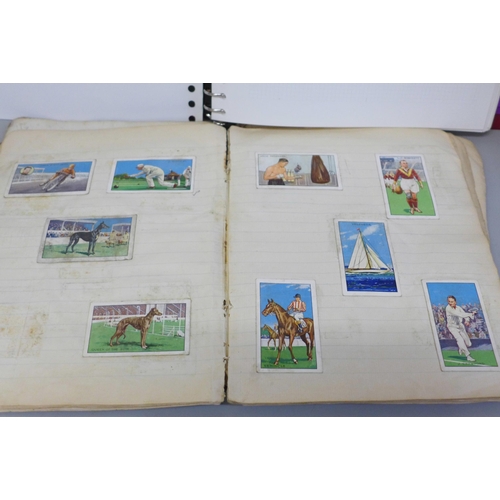 656 - A stamp album containing world stamps, a collection of vintage comic postcards and a notebook contai... 